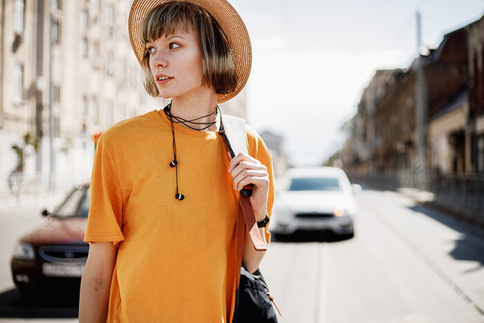 young girl with headphones on a yellow shirt